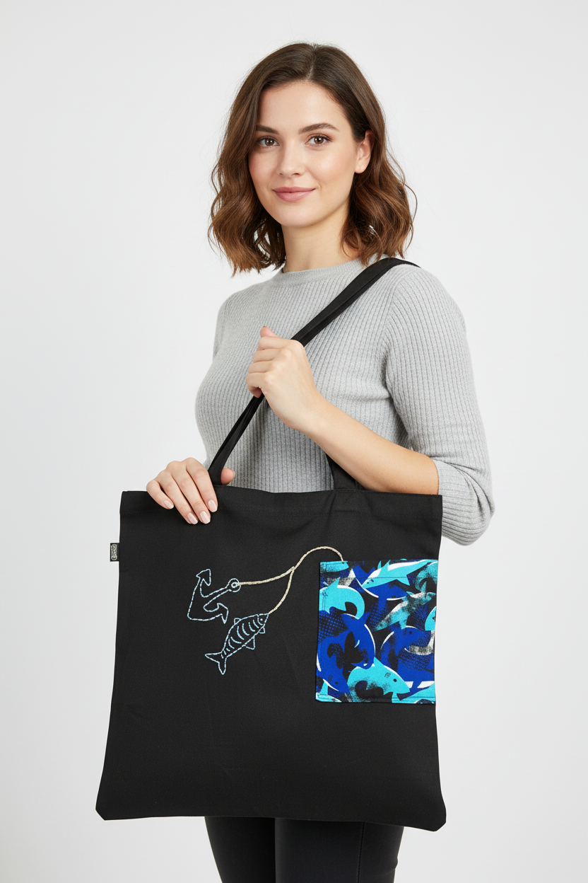 Woman holding black fish tote bag