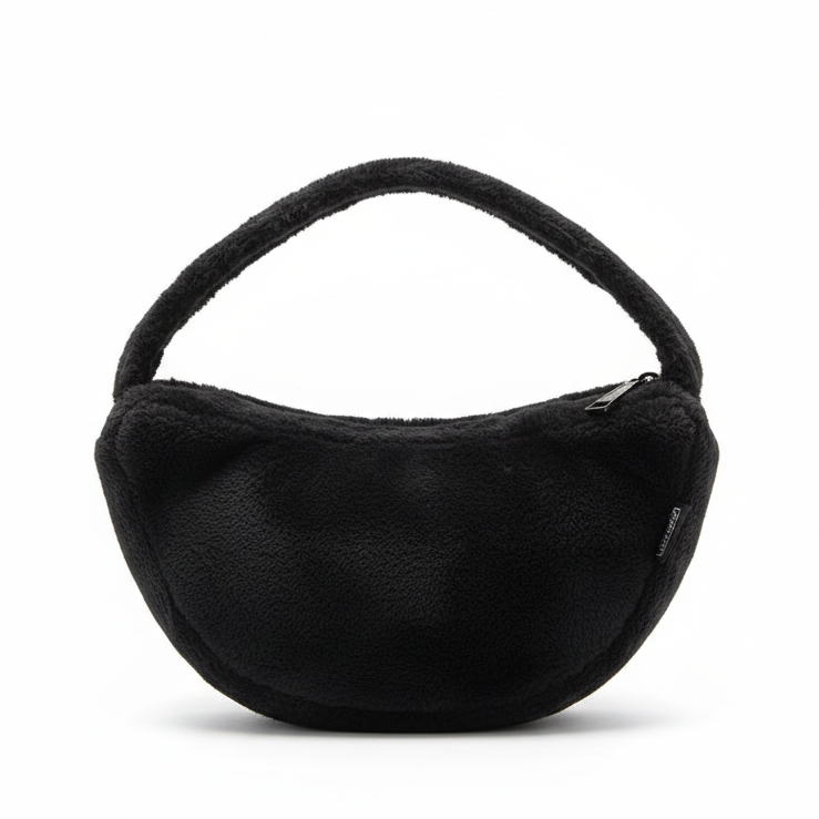 Black furry handbag on white background