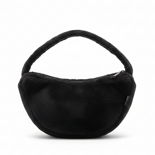 Black furry handbag on white background