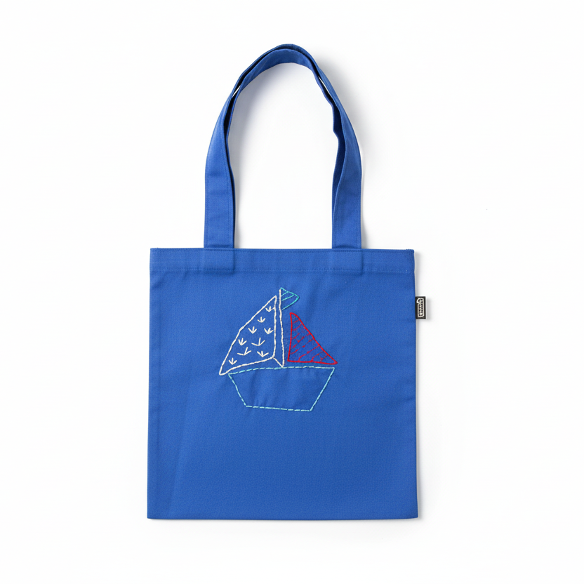 Blue tote bag with sailboat design on white background