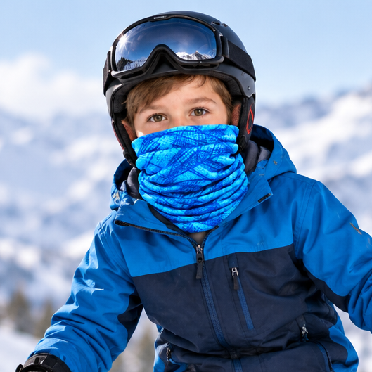 Boy skiing in the snow wearing blue patterned headgear