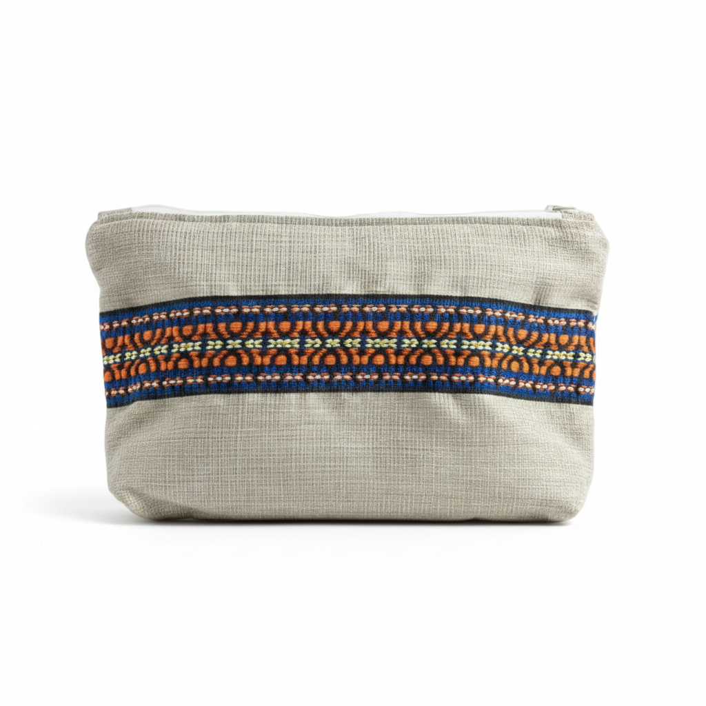 Cream beige woven clutch with blue and orange embroidered trim on white background