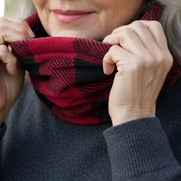 Grandmother putting the red-and-black plaid headgear around her neck