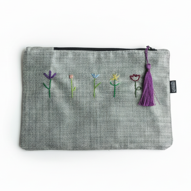 Gray pouch with embroidered flowers on white background