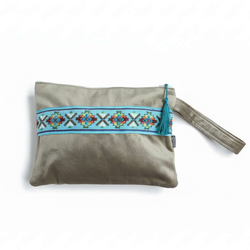 Gray wristlet clutch with turquoise embroidered trim on white background