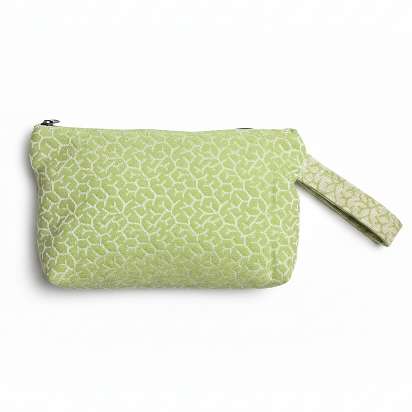 Light green sage wristlet clutch with textured geometric pattern on white background
