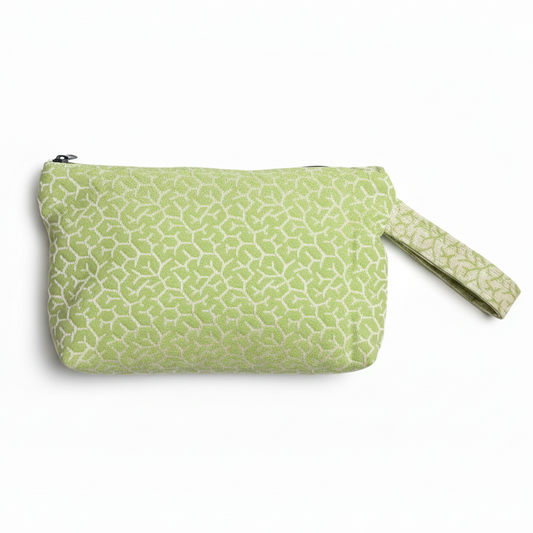 Light green sage wristlet clutch with textured geometric pattern on white background