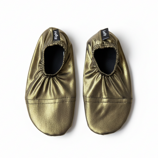 Metallic gold shoes on white background