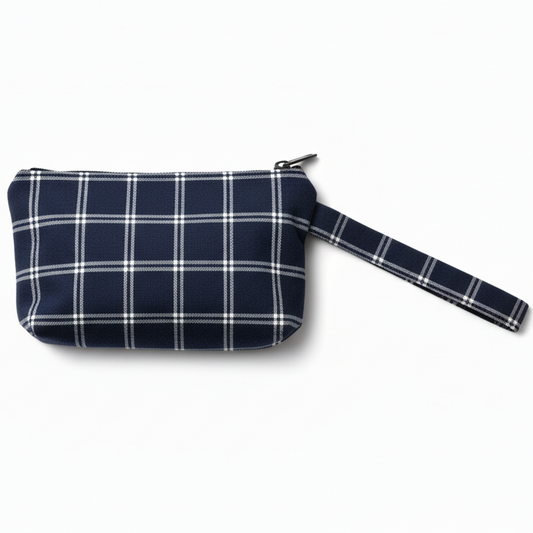 Navy blue and white plaid wristlet clutch on white background