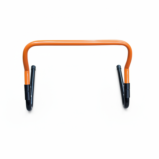 Orange agility hurdle with black feet white background