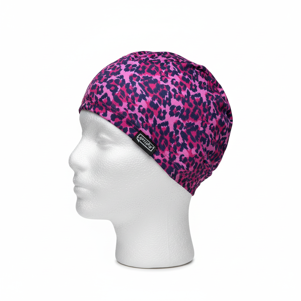 Pink and navy leopard print lycra cap on mannequin - left side view with brand