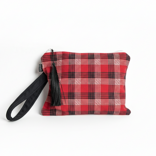Red and black plaid wristlet clutch with white trim on white background