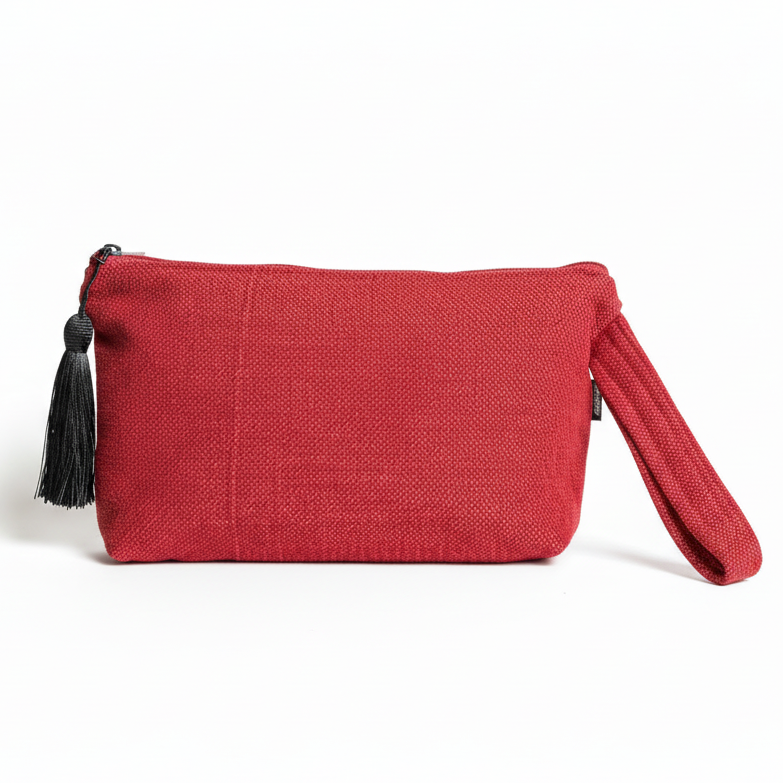 Red textured woven wristlet clutch with black tassel on white background