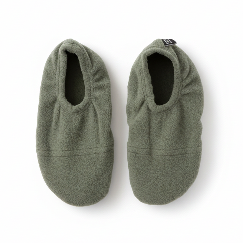 Sage green fuzzy slippers on white background