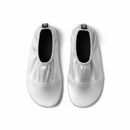 Silver metallic water shoes on white background
