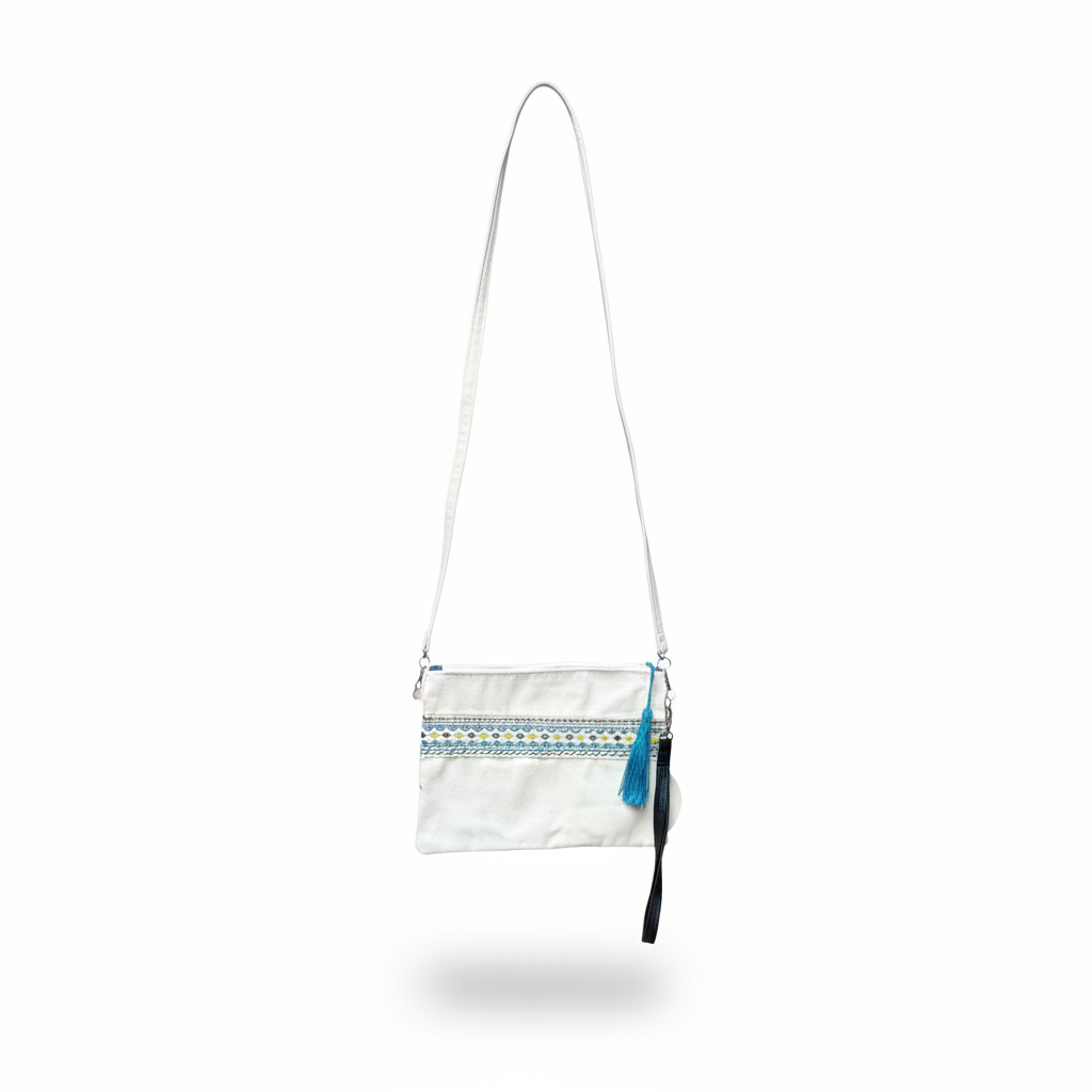White crossbody bag hanging without visible hook