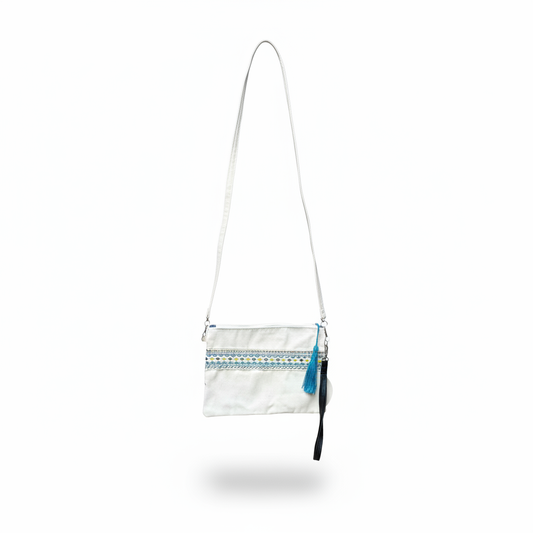 White crossbody bag hanging without visible hook